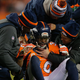 Strong safety David Bruton of the Denver Broncos is attended to by trainers after a play that would force him out of the game with a reported concussion during a game against the Oakland Raiders at Sports Authority Field at Mile High on Dec. 28, 2014, in Denver. (Doug Pensinger/Getty Images)